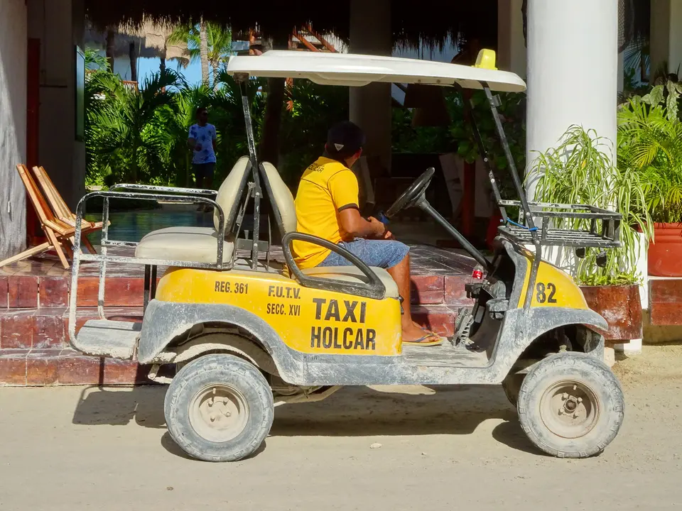 Taxi de carrito de golf en una calle de arena de Holbox